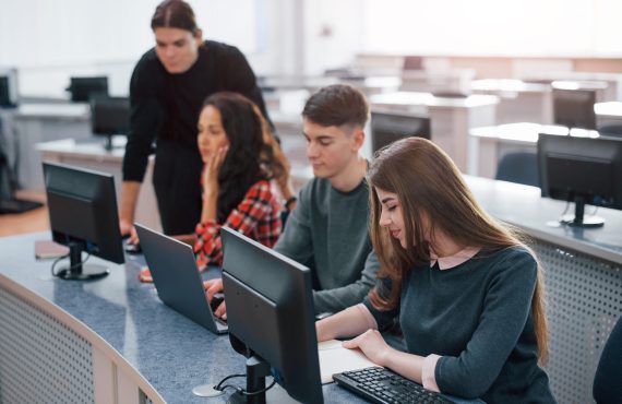 Spacious area. Group of young people in casual clothes working in the modern office.